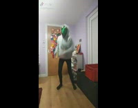 Guy wears green frog mask, does the shoot dance to Barney theme song trap remix and slips on floor