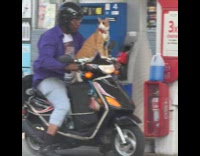 Cat on motorcycle wearing sunglasses, goldchains and red bowtie 
