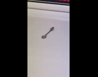 Small teaspoon on commercial laundry dryer machine