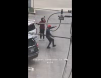 Guy holds camera films video friend dances 