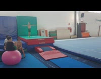 Green shorts kid does flips across mats 
