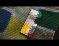 phone camouflages with colorful quilt blanket 