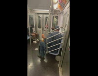 Guy holding orange juice blasts music on subway 