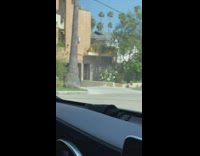 Woman white shorts butt bag driveway tripod