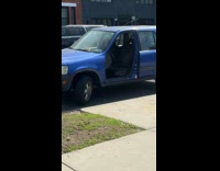 Blue car no front door at street