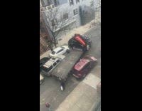 Tow truck struggles to drive down street 