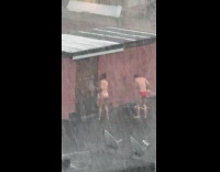 Man and woman showers in the rain