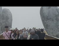 Three women jump dance middle of bridge tourist music