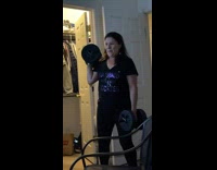 Mother black shirt lift two dumbbells workout