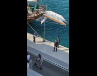 Two men poses at the boat dock