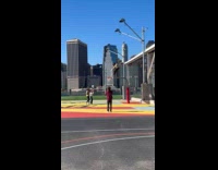 Woman shoots basketball cameraman on hoop arm