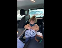 Kid falls while putting toys in bag 