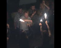 Guy dances with slinky girls hold sparklers 