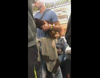 Man blue shirt  holds brown pet chicken on subway 