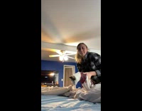 Girl in sweater rolls over and falls over in bed