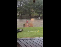 Couple swimming on lake while raining 