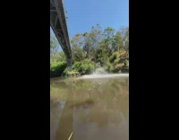 Guy backflips off bridge into mud river 