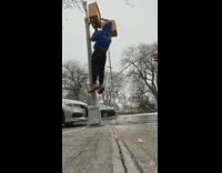 Guy does pull ups outside in snow 