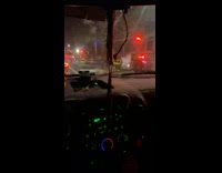 Driving past a car engulfed in smoke on road