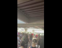 Crowd of people walks inside the attraction with and without masks