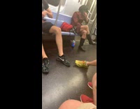 Man in red dress black boots with pepsi bottle on the ground on subway