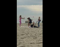 Pink leggings girl holds two bottles beach 