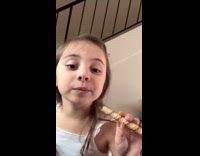 Kid pretends to smoke using wafer stick