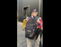 Guy in white jumpsuit models with leg 