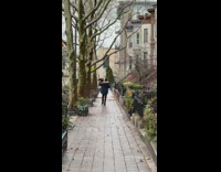 Person walks with rooster on shoulder 
