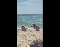 Woman bikini lays on beach rock for photoshoot Part 1