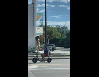 Shirtless guy wearing underwear poses under balcony 