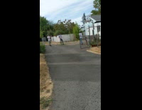 Man throws fruit and sliced it with a sword at the yard