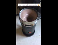 Guy mixes hot chocolate in milk frother 