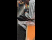 Man sets up smoke tube inside train