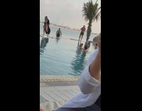 Woman bikini black robe walk pool side