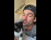 Guy attempts to kiss black white kitten