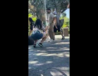 Man in brown outfit poses with a waterfalls behind