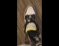 Guy using scissors to cut ankle bracelet 