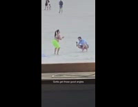 Lady does squats on beach for video