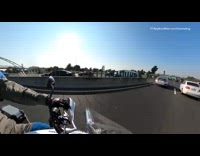 Guy on motorcycle catches trash litter freeway