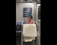 Lady smokes cigarette subway train walker headphones 