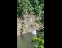Guy jumps off cliff water work friend