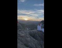 Guy white shirt get haircut on mountain