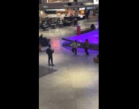 Two men dances front of mall fountain