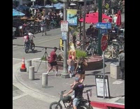 Woman slaps butt of another woman on the sidewalk