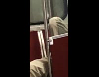 Man coughs loud and lays on subway seats with bare feet on window walls
