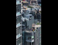 Collab IITW - Man blue shirt dances on building balcony