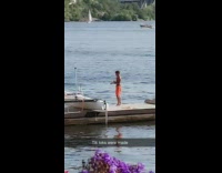 Guy orange shorts dance tikkok pier boat