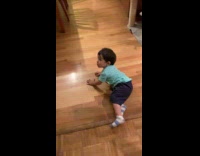 Little boy walking funny trips on floor