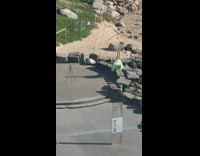 Woman handstand on rock green tutu 